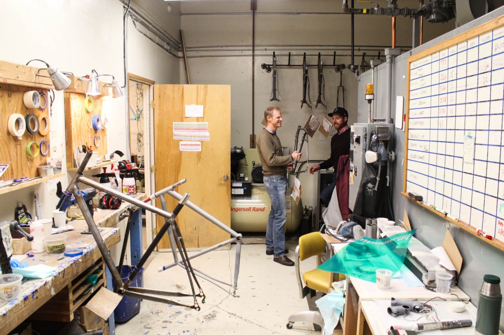 A door in the shop opens to the paint area, aka Coat, where finished frames are given candy coatings in any hue that clients request. Peder and Tom in the background are discussing Peder's Vanilla touring bike, which is about a month away from completion and about to get it's paint.