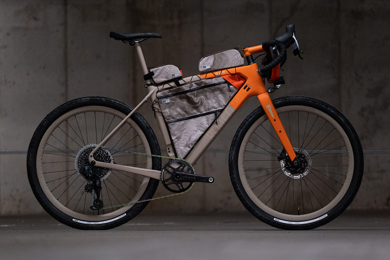 Orange and grey custom cerakote painted Rodeo Labs Traildonkey carbon gravel bike. Bikepacking setup with full frame bag and top tube bags.