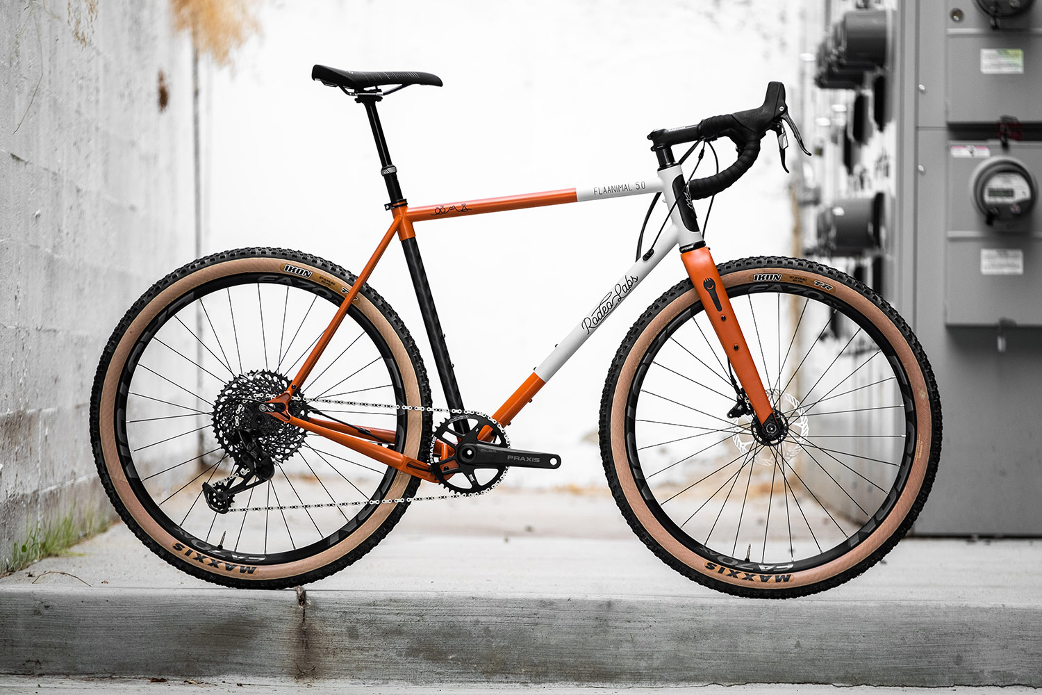 Orange and white custom cerakote Rodeo Labs Flaanimal steel gravel bike.