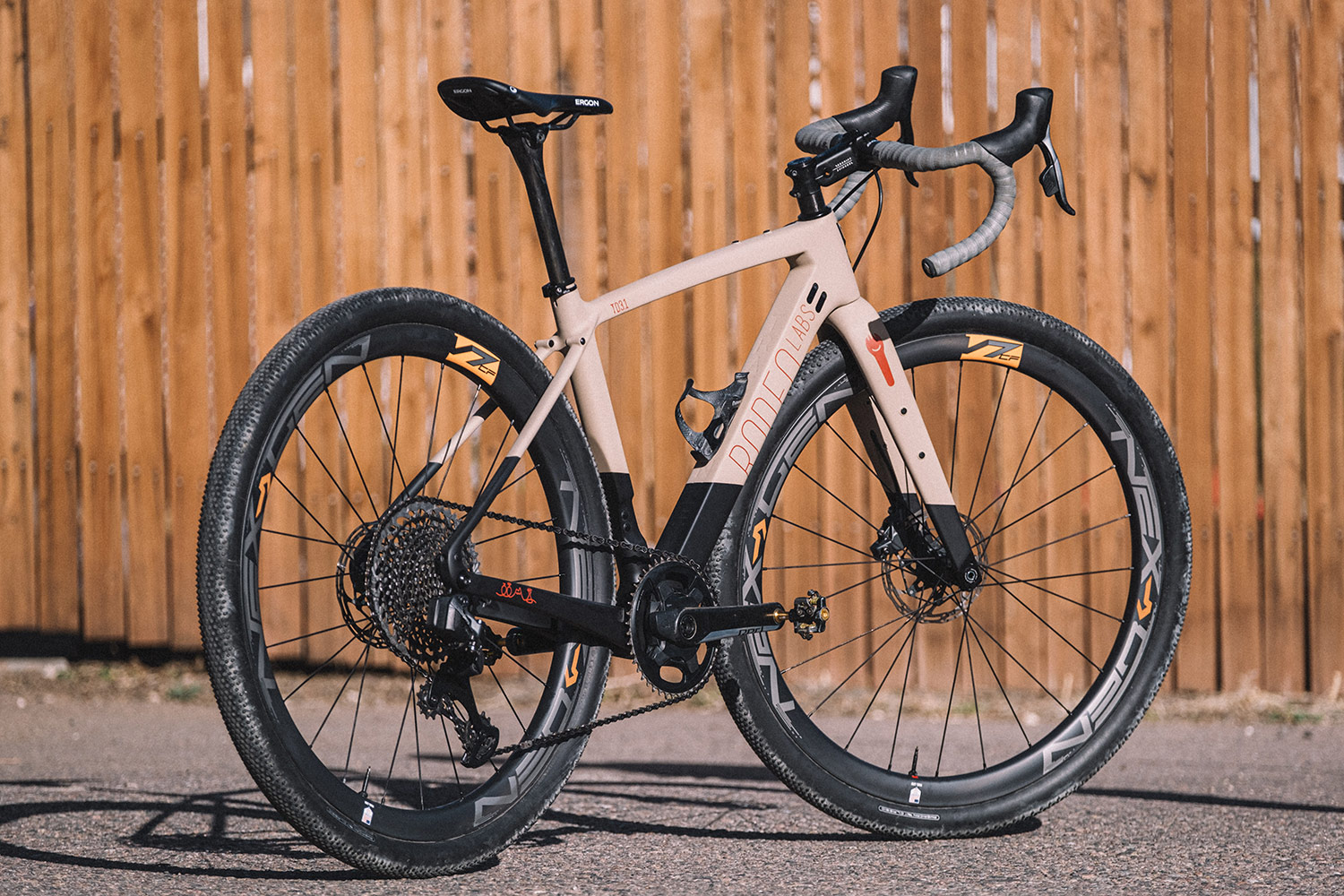 Pink, orange, and black custom cerakote Rodeo Labs Traildonkey carbon gravel bike with grey bar tape.