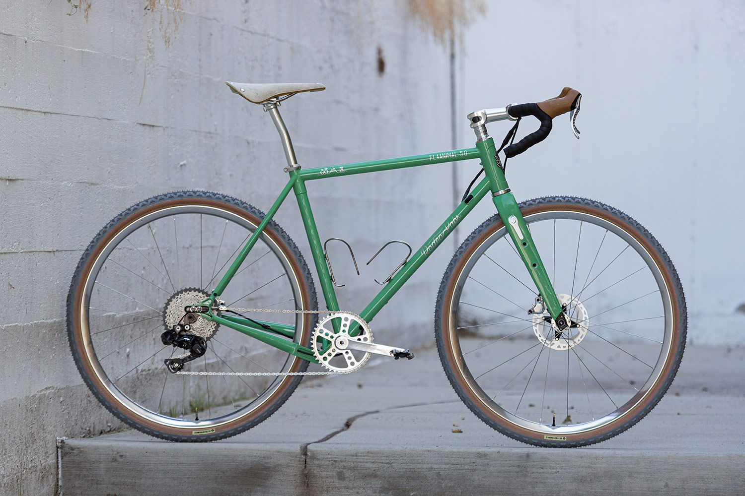 Green, white, and silver custom cerakote Rodeo Labs Flaanimal steel gravel bike.
