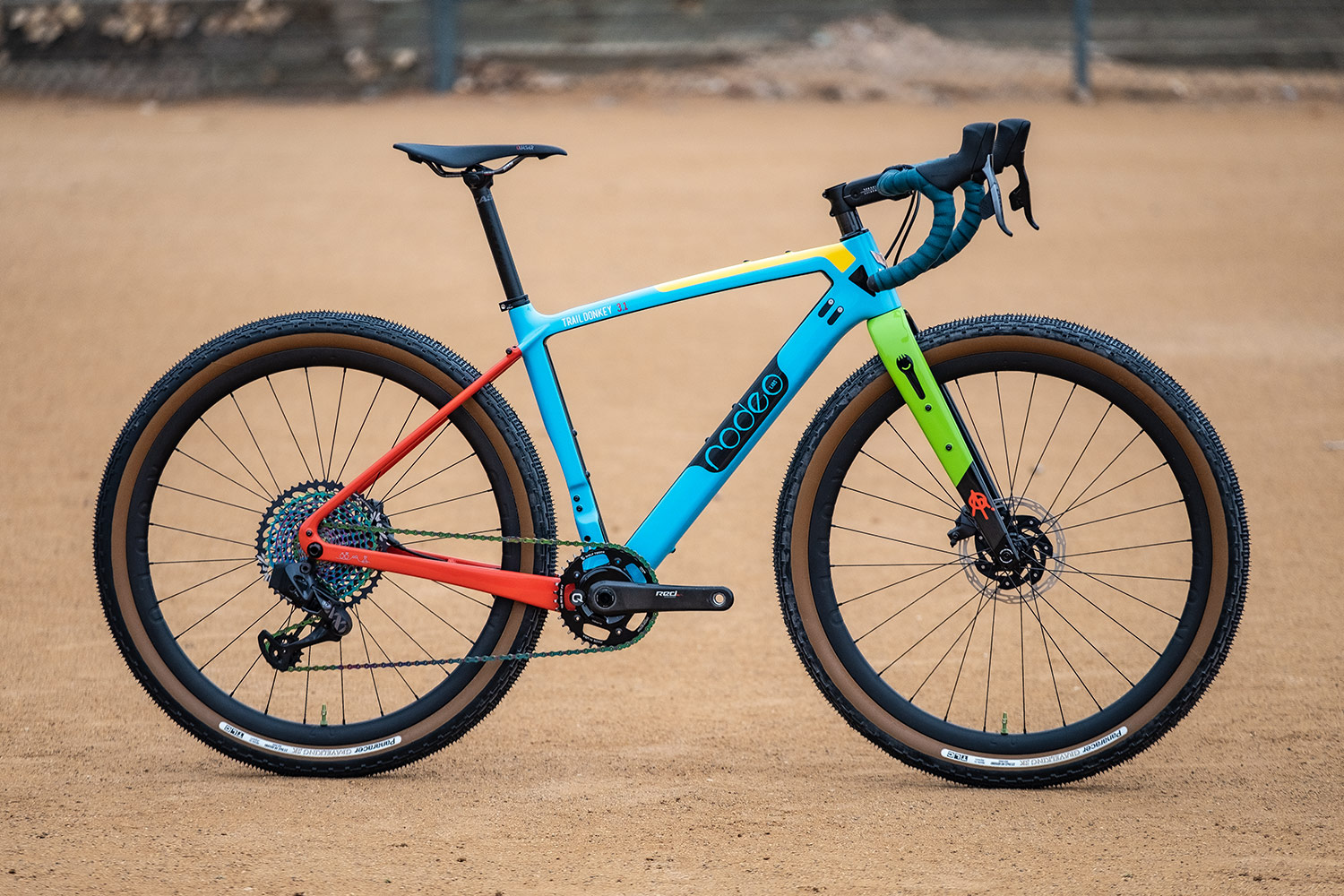 Blue, red, green, yellow custom cerakote painted Rodeo Labs Traildonkey carbon gravel bike.