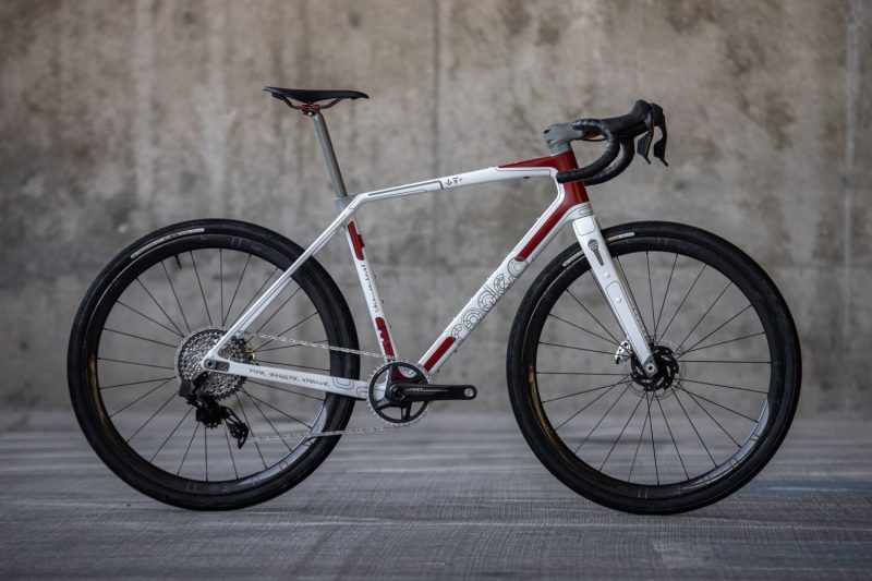 Star Wars themed Rodeo Labs Traildonkey bike. The language used in the film is replicated on the bicycle. A custom Spork logo is wearing a rebel fighter helmet. This bicycle is white and red with a Star Wars inspired design made to mimic the rebel fighter ships.