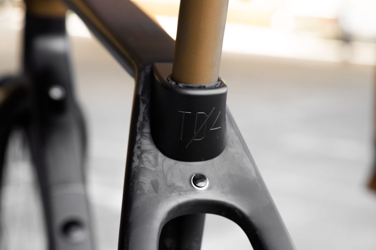Rodeo Labs Traildonkey TD4.2 carbon bike with black TD4 embossed seat collar or seatpost clamp. The seatpost is color matched to bronze like the paint on the frame.